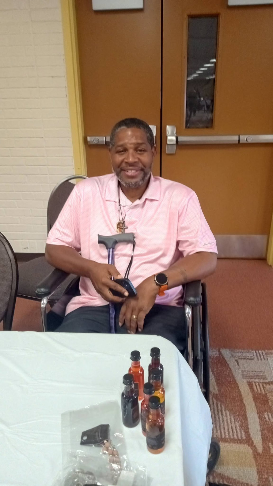 A guest smiling at his table with a wine tasting flight in front of him.