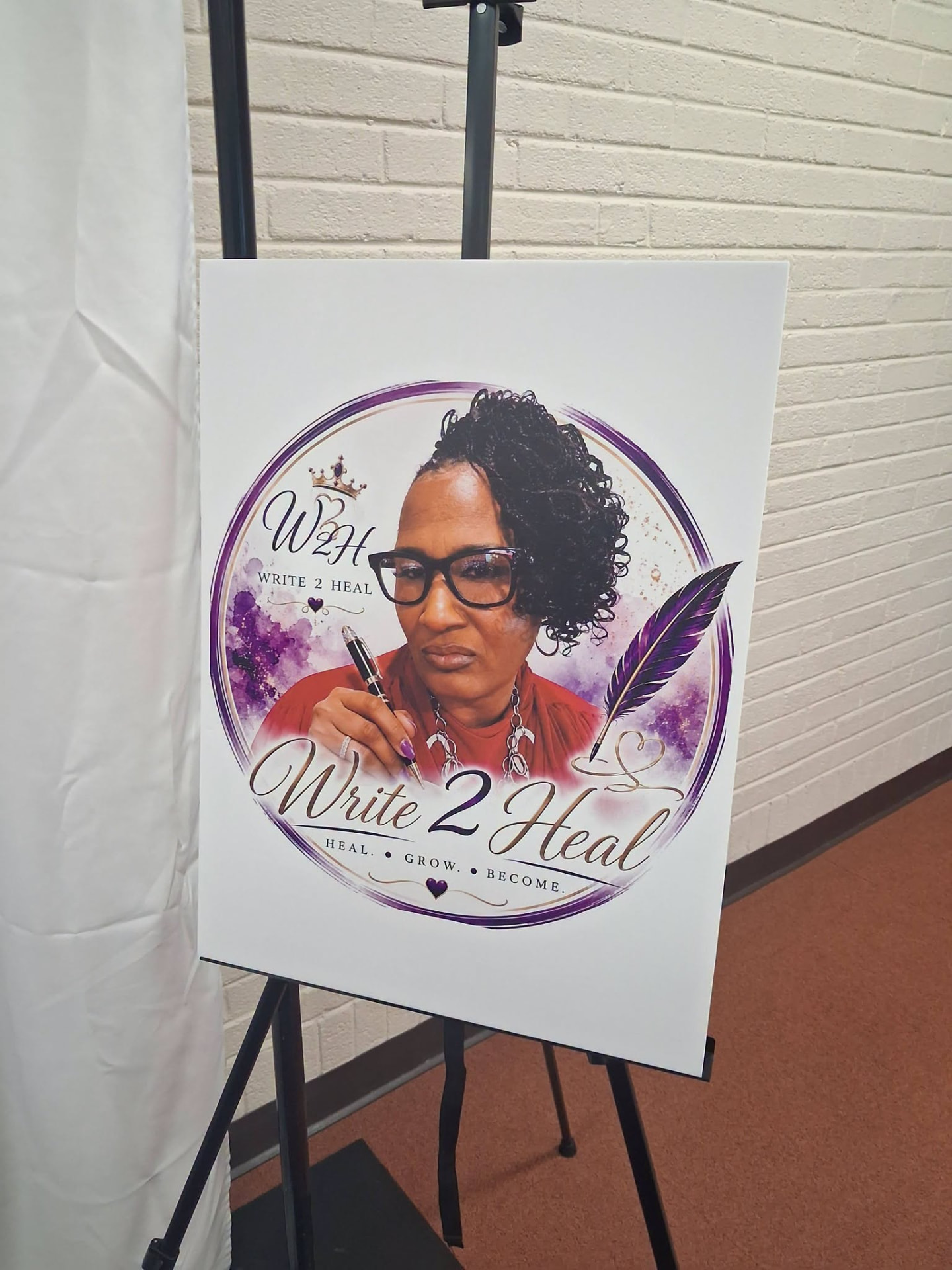 The Write 2 Heal logo poster on an easel welcoming guests.